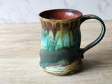 Unique pottery cup – hand‑glazed green and amber mug with organic form