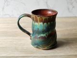Wheel‑thrown ceramic mug with altered shape and textured base