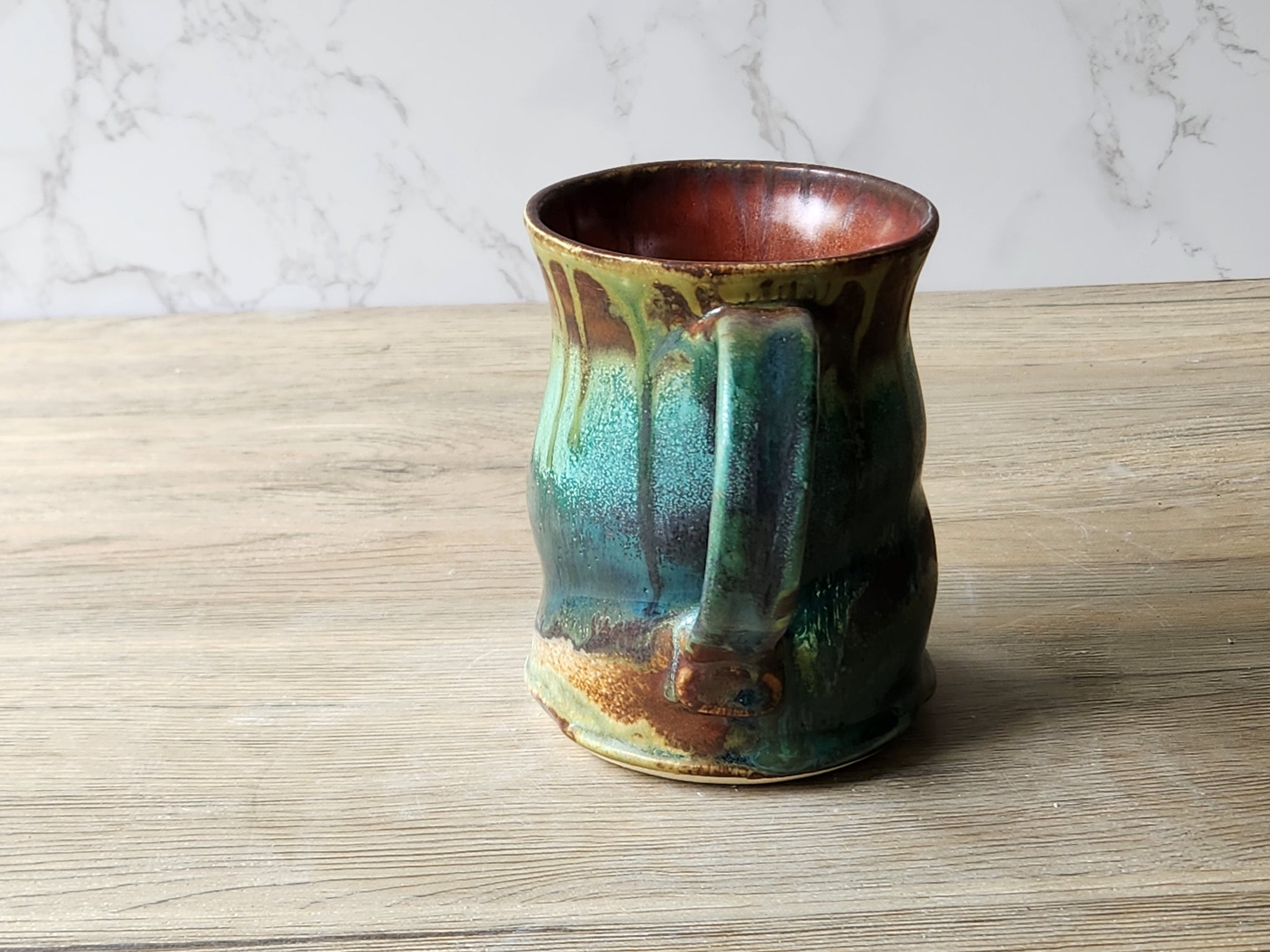 Rustic stoneware coffee mug – red‑brown interior and flowing ash glaze drips