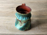 View of inside red glaze of handmade ceramic coffee mug