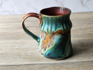 Side view of handmade ceramic cup with earthy glaze