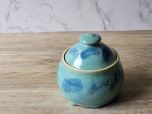 Speckled green and blue pottery sugar jar with domed lid