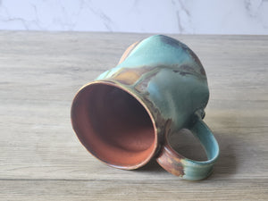 View of inside red glaze of ceramic coffee mug