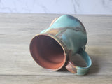 View of inside red glaze of ceramic coffee mug