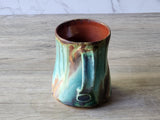 Handle detail of handmade green pottery mug