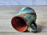 Artisan ceramic mug with twisted shape