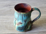 Interior view of handmade mug showing warm brown glaze