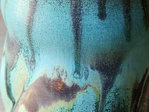 close up of rustic glazes on the handmade pottery mug.