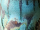 close up of rustic glazes on the handmade pottery mug.