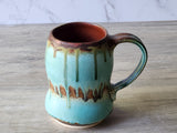 Red-brown glazed interior of handmade ceramic cup