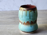 Artisan coffee mug with flowing glaze pattern