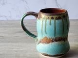 Handle detail of uniquely shaped ceramic mug