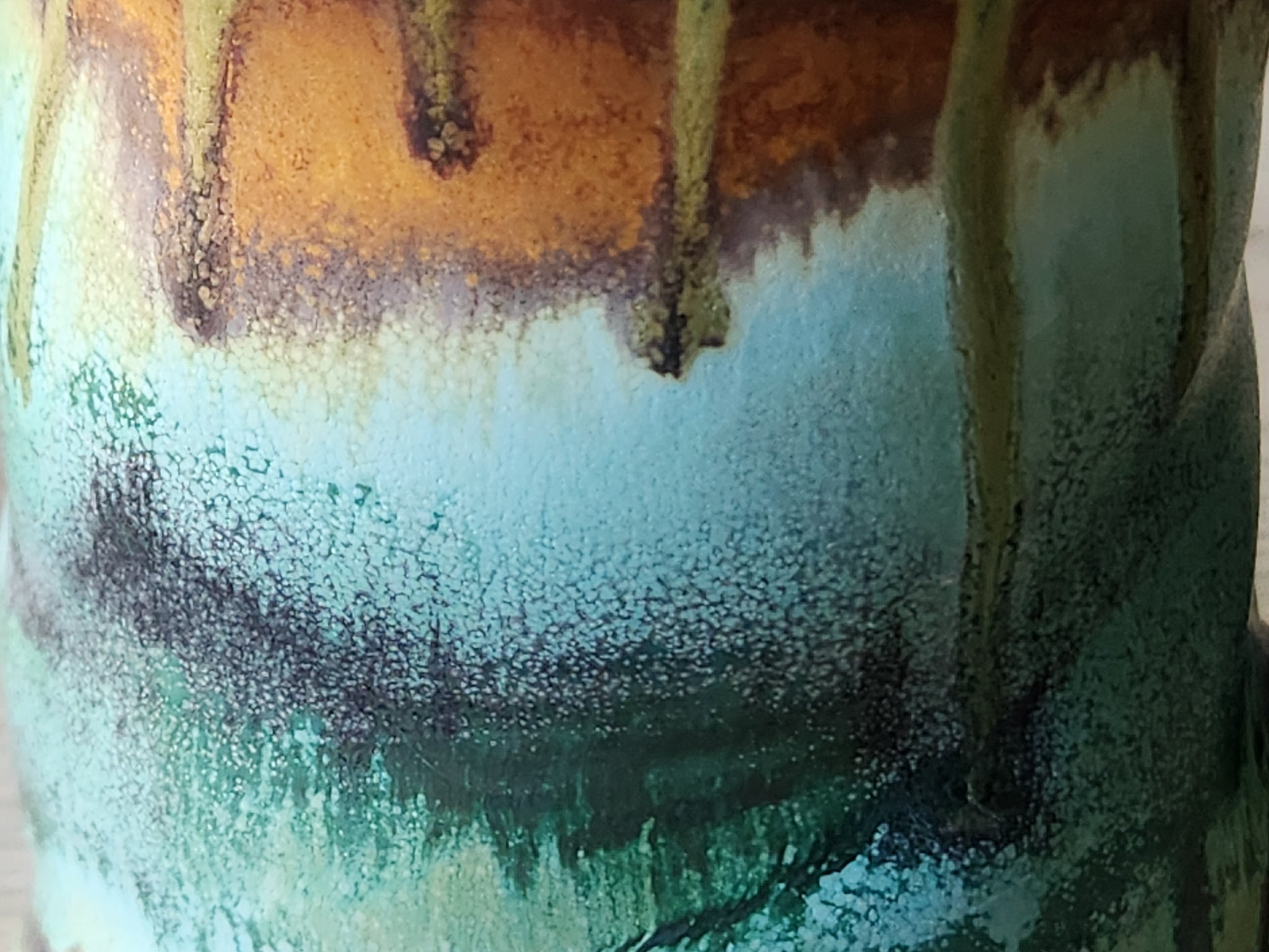 Close-up of rustic glaze patterns on pottery mug