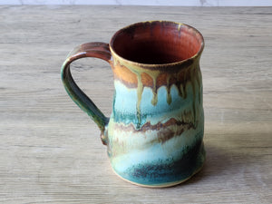 Rustic handmade coffee mug with green and brown drips