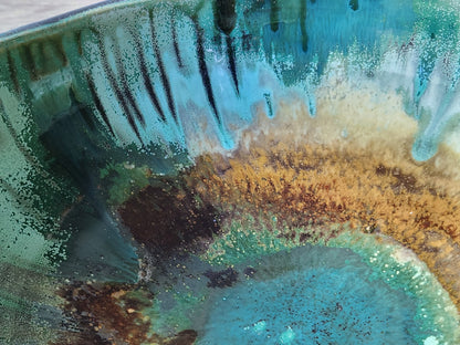 Close up of glaze on the Aqua and emerald green pottery bowl with glossy  and matt finish