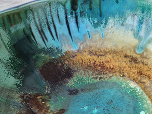 Close up of glaze on the Aqua and emerald green pottery bowl with glossy  and matt finish