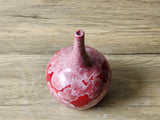 Glossy red ceramic vase with natural crystals