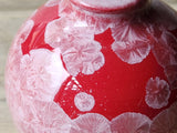 Close-up of crystalline glaze on red pottery vase