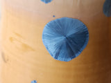 Close-up of blue crystals on amber ceramic mug
