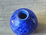 Round porcelain vase with bright blue crystal glaze finish