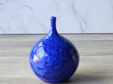 Hand-thrown ceramic vase with deep blue crystalline surface