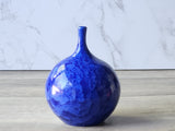 Decorative ceramic bud vase featuring dense crystal clusters