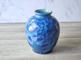 Side view of a decorative blue ceramic art vase made in Australia