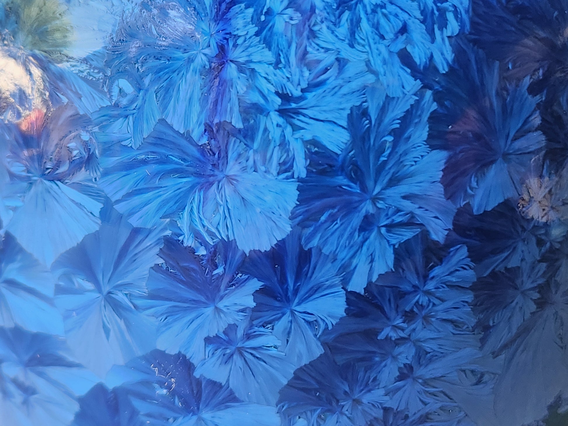 Close up of the blue crystal pattern pottery vase, showing the shine from the glossy glaze on the upper left.