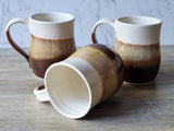 Handmade ceramic mug set showing interior and glaze detail, earthy stoneware pottery