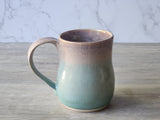 Single handmade pottery mug with curved handle and green glaze, Australian stoneware mug