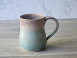 Handmade stoneware mug with curved handle and subtle glaze variation, ceramic pottery mug