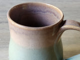 Close-up of handmade ceramic mug showing glazed rim and interior, Australian stoneware pottery