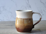 Extra large handmade ceramic mug showing handle attachment, earthy glazed stoneware coffee mug