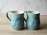 “Handcrafted stoneware mugs with ocean-inspired blue green glaze, side view, made in Melbourne.
