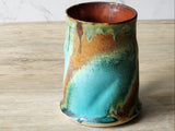 Unique handmade pottery mug with glossy interior and textured exterior glaze