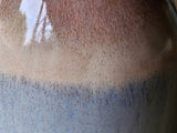 Close-up of oatmeal and blue glaze on handmade ceramic bud vase, handmade pottery Melbourne Australia