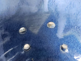 Close-up detail of blue glazed ceramic berry bowl with hand-pierced drainage holes