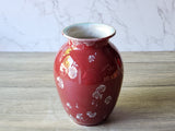 Angled top view of red crystal glaze vase highlighting rim and glossy interior