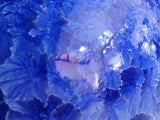 Close-up of cobalt blue crystalline glaze crystals on handmade ceramic bud vase