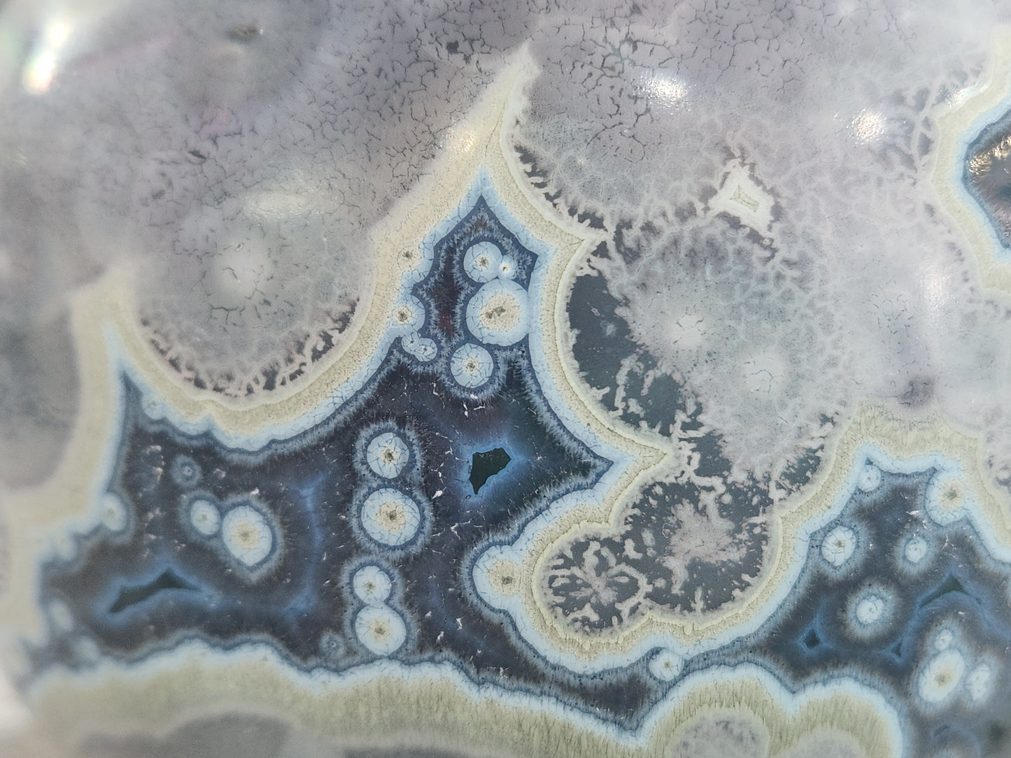 Close up of deep galaxy crystalline glaze with star-like crystal blooms on handmade ceramic vase
