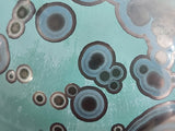 Macro detail of multiple crystal rings on teal galaxy glaze ceramic vase handmade