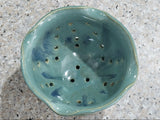 Handmade ceramic berry bowl in seafoam green with blue accents