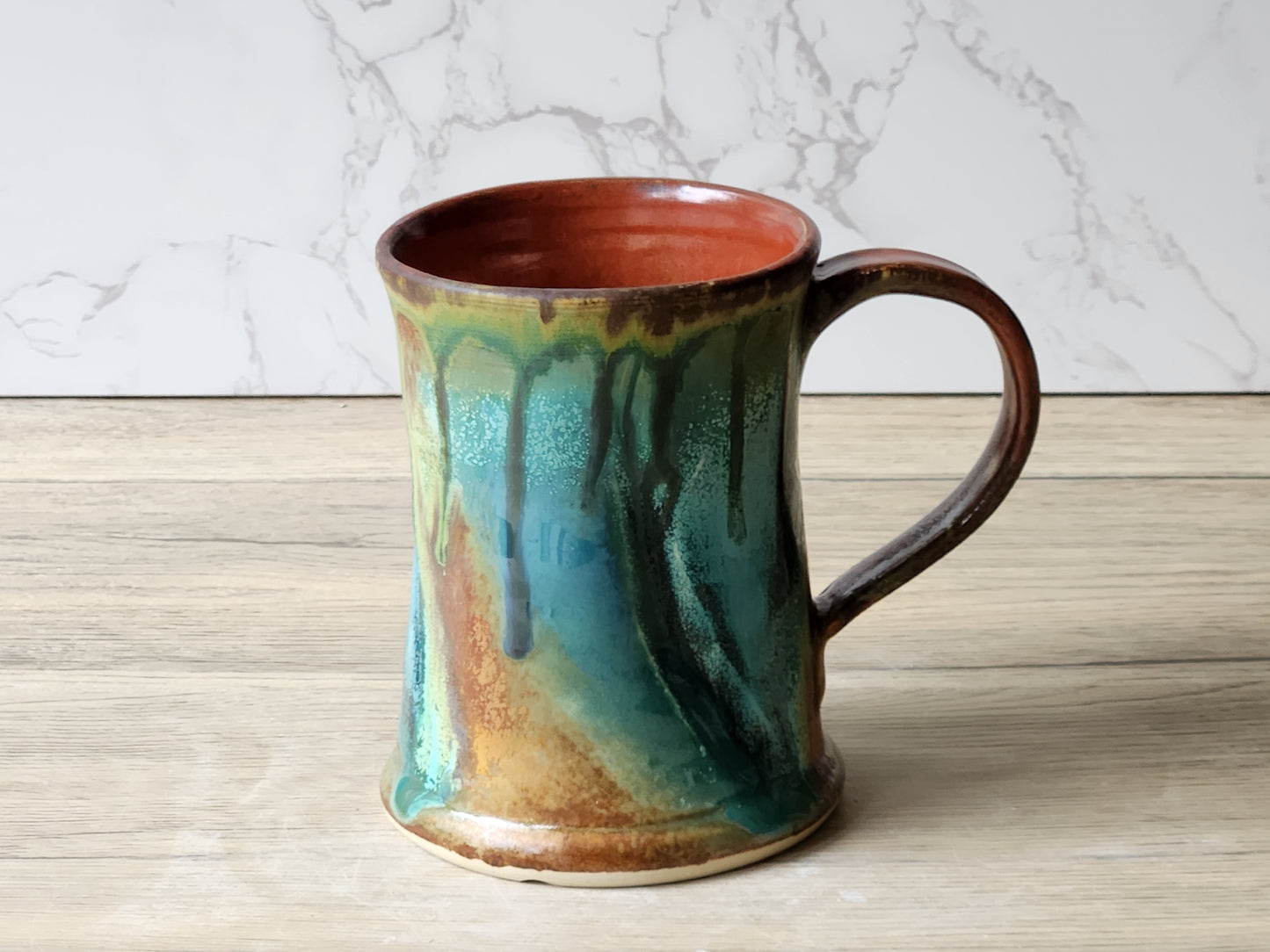 Buxton Pottery handmade mug with flowing green glaze and rustic handle