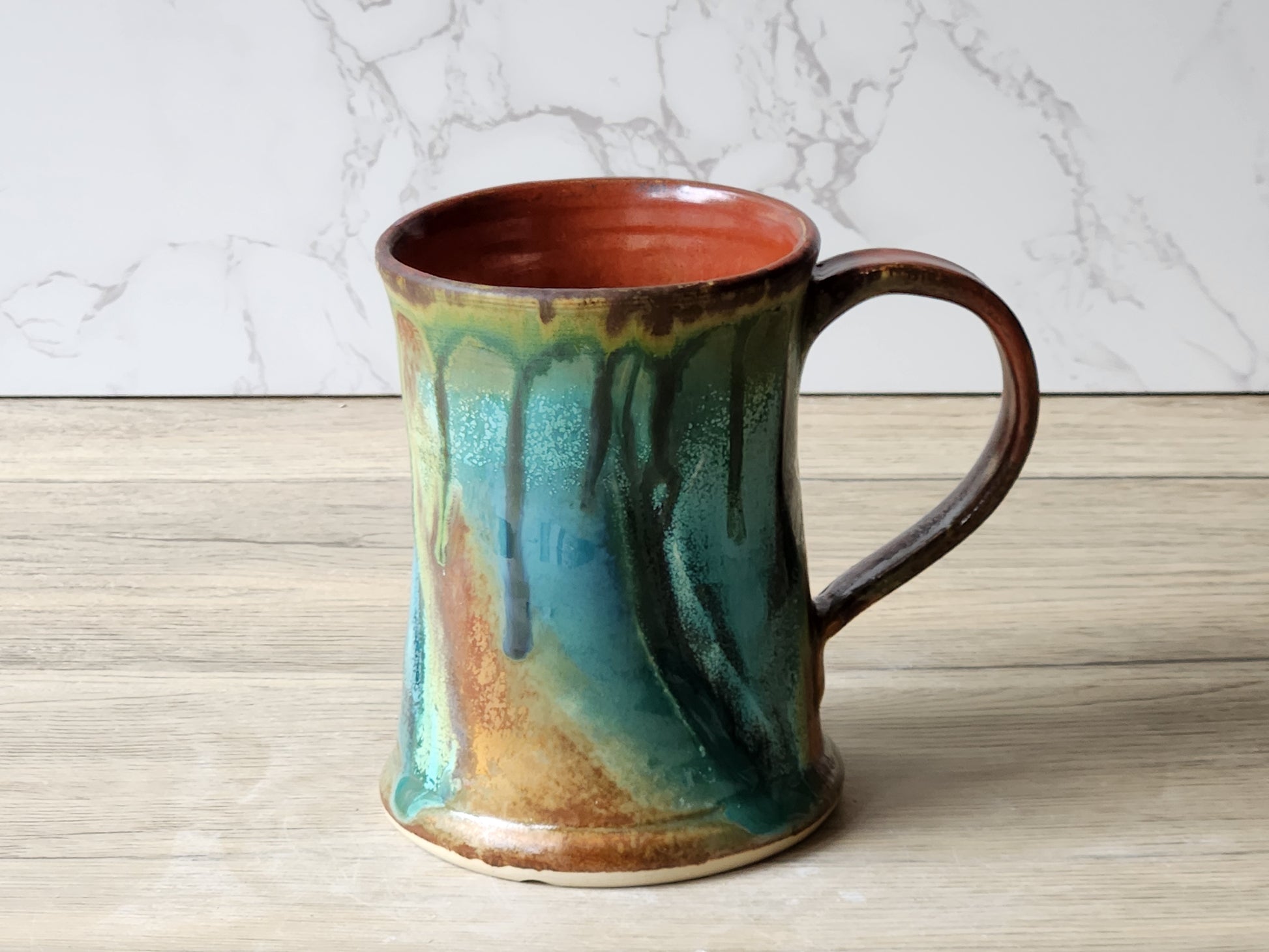 Buxton Pottery handmade mug with flowing green glaze and rustic handle