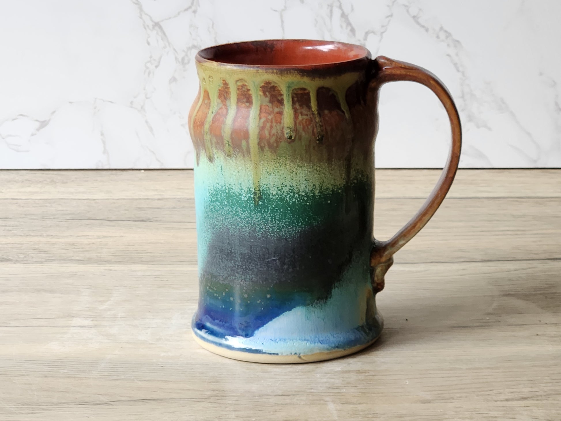 Handmade ceramic coffee mug with galaxy glaze, blue green and copper tones