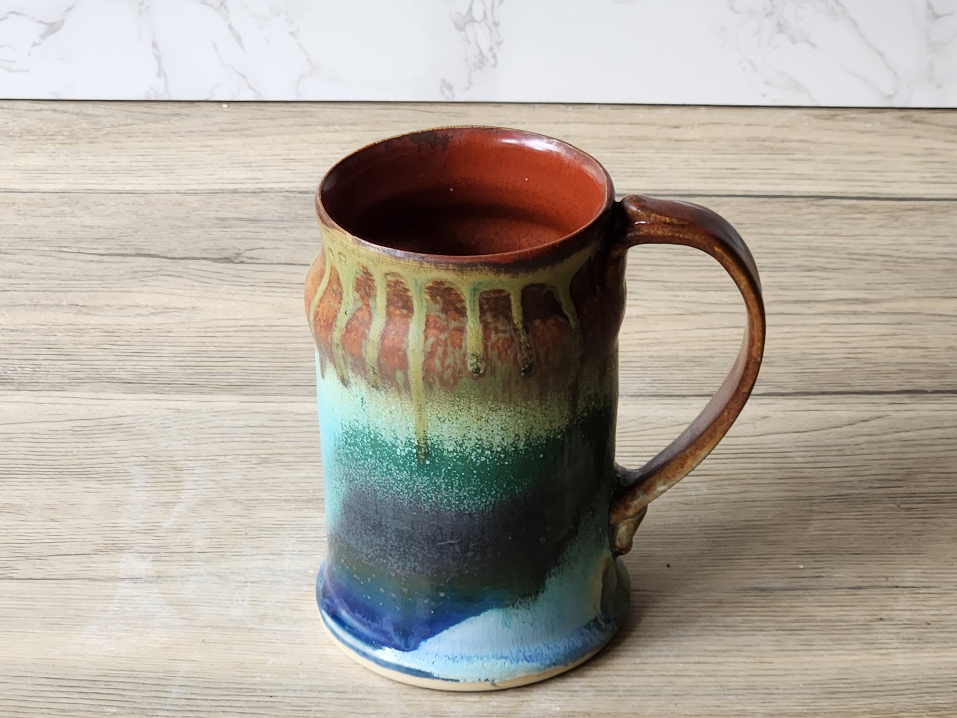 Handmade stoneware mug with curved handle and glossy galaxy glaze finish
