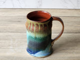 Handmade stoneware mug with curved handle and glossy galaxy glaze finish