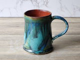 Handmade pottery mug with teal and forest-green glaze and rust interior, Buxton Pottery Melbourne