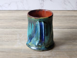 Detail of mug base and glaze pooling on handmade stoneware coffee cup