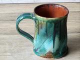 Top view of handmade ceramic mug showing rust brown interior glaze
